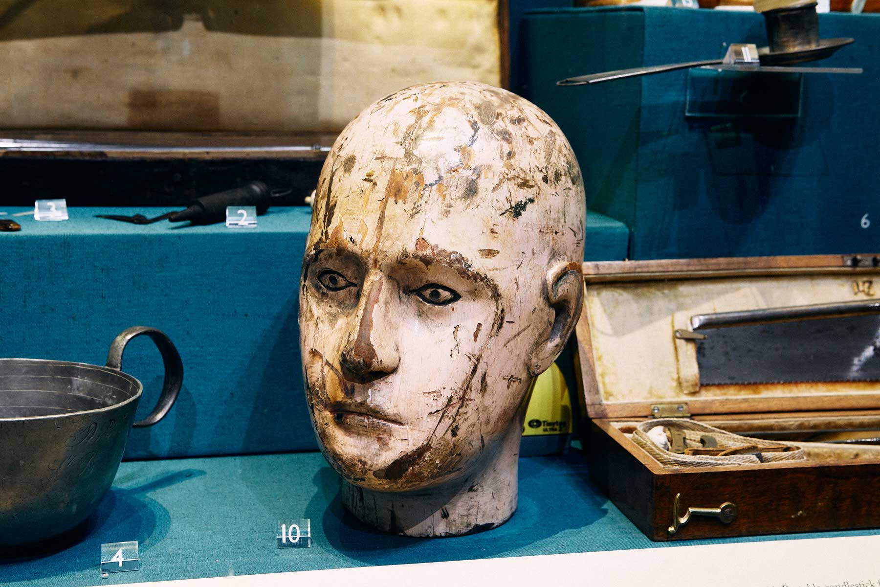 Wooden head used to practice drilling into the skull